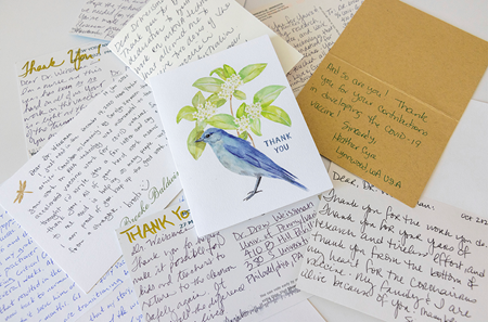 A pile of postcards and thank-you notes addressed to Drew Weissman, with messages expressing gratitude for his research with Katalin Kariko that led to COVID-19 vaccines